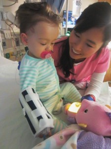 10am - With the help of her favorite 3J nurse,Trang, Peanut sat up for the first time post surgery.  Not yet steady enough to sit alone.  The morphine likely had a little to do with that!